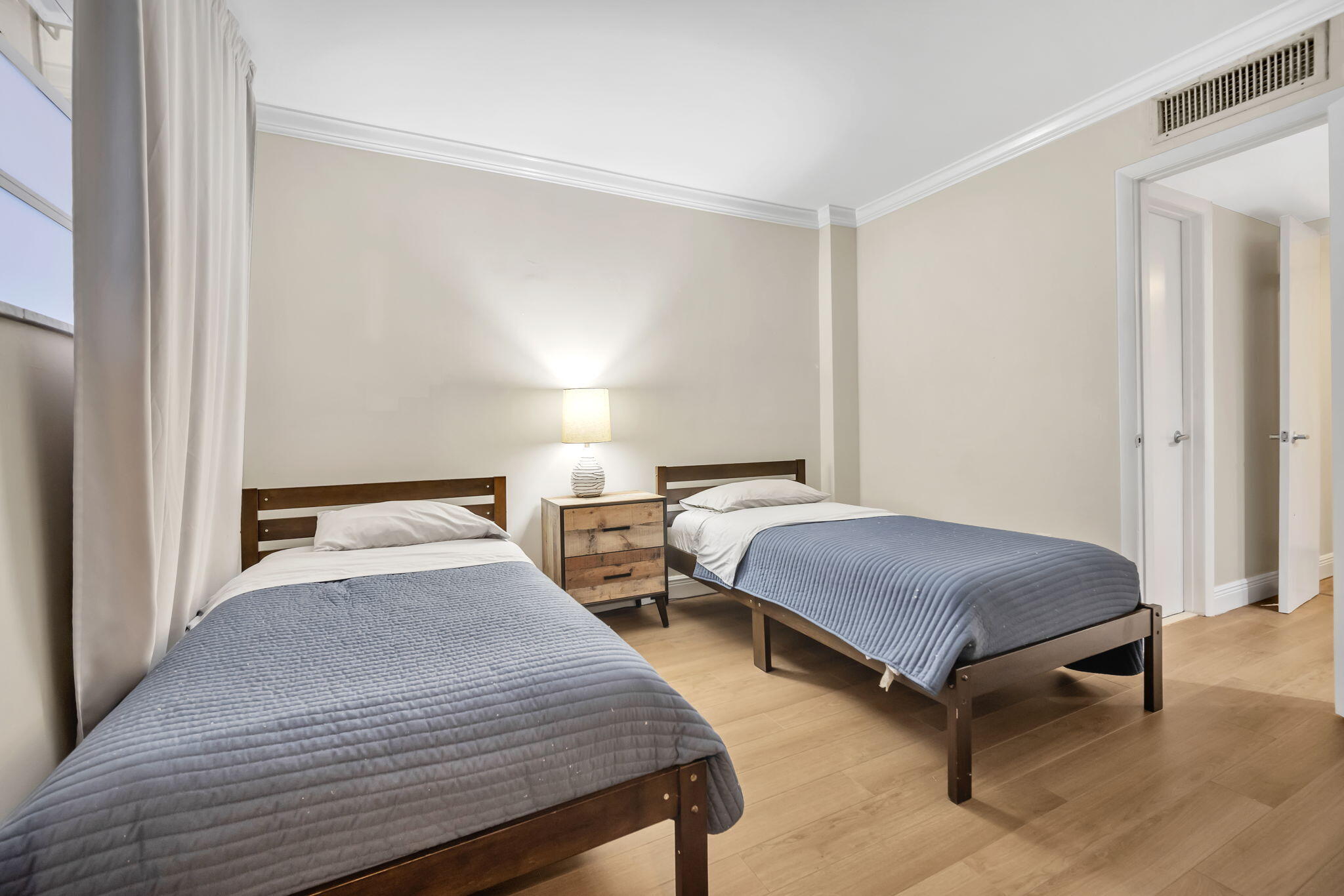 777 Northeast 62nd Street, Unit C512 Miami, FL 33138 - Photo 21 of 40 a bedroom with two beds and a night stand