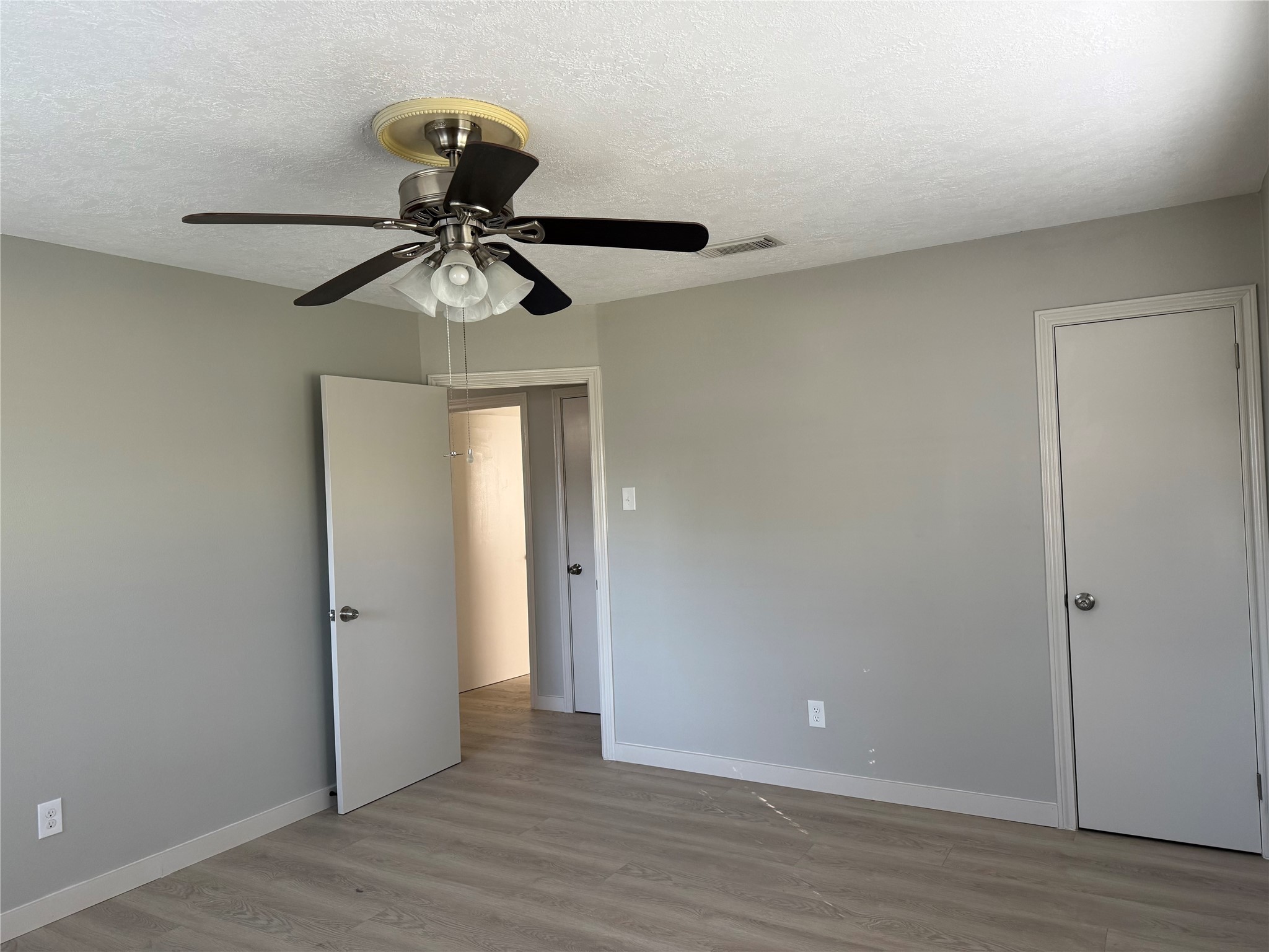 5622 Killough Street Houston, TX 77086 - Photo 17 of 21 a view of a chandelier fan and wooden floor