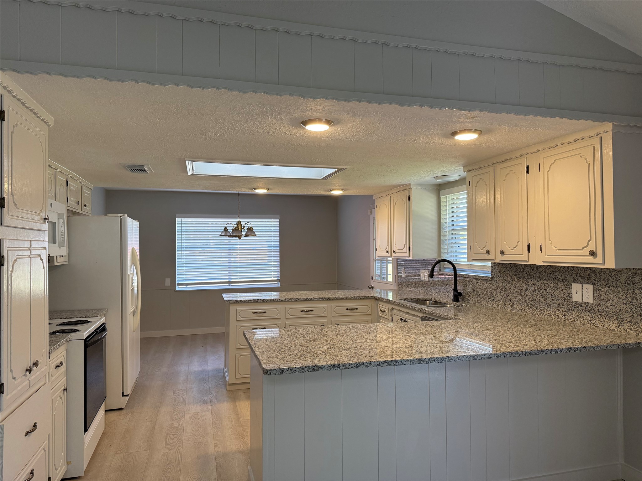 5622 Killough Street Houston, TX 77086 - Photo 7 of 21 a kitchen with stainless steel appliances granite countertop a sink stove and refrigerator