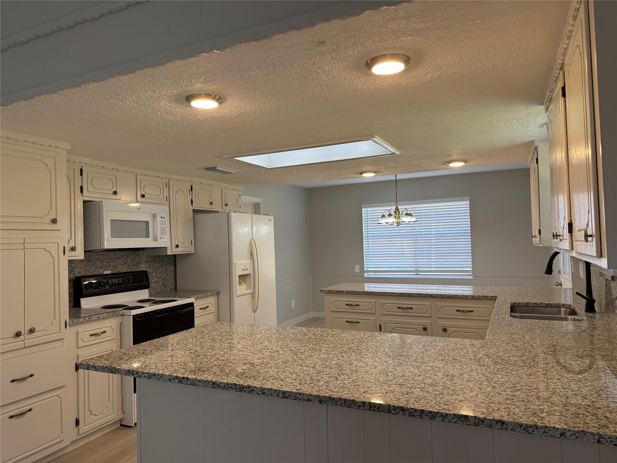 5622 Killough Street Houston, TX 77086 - Photo 9 of 21 a kitchen with stainless steel appliances granite countertop a sink a stove and a refrigerator