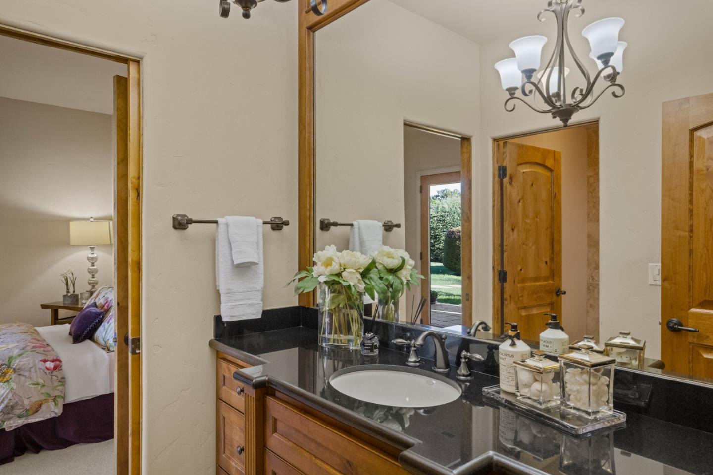 11550 Spur Road Monterey, CA 93940 - Photo 40 of 60 a bathroom with a granite countertop sink a toilet and a mirror