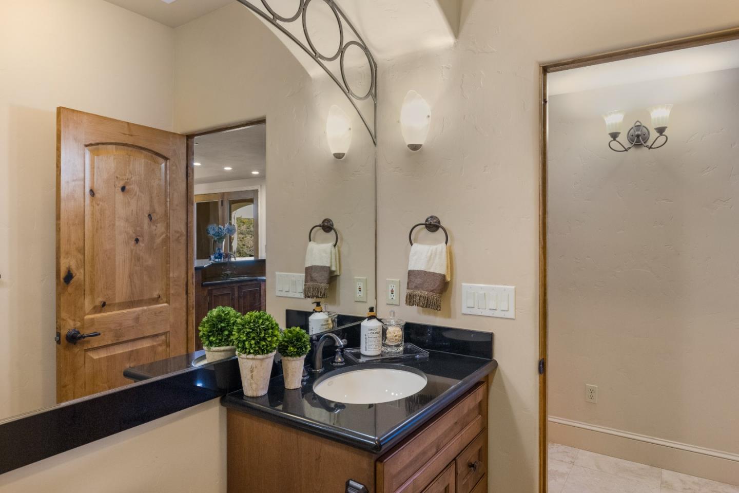 11550 Spur Road Monterey, CA 93940 - Photo 41 of 60 a bathroom with a granite countertop sink a mirror and shower