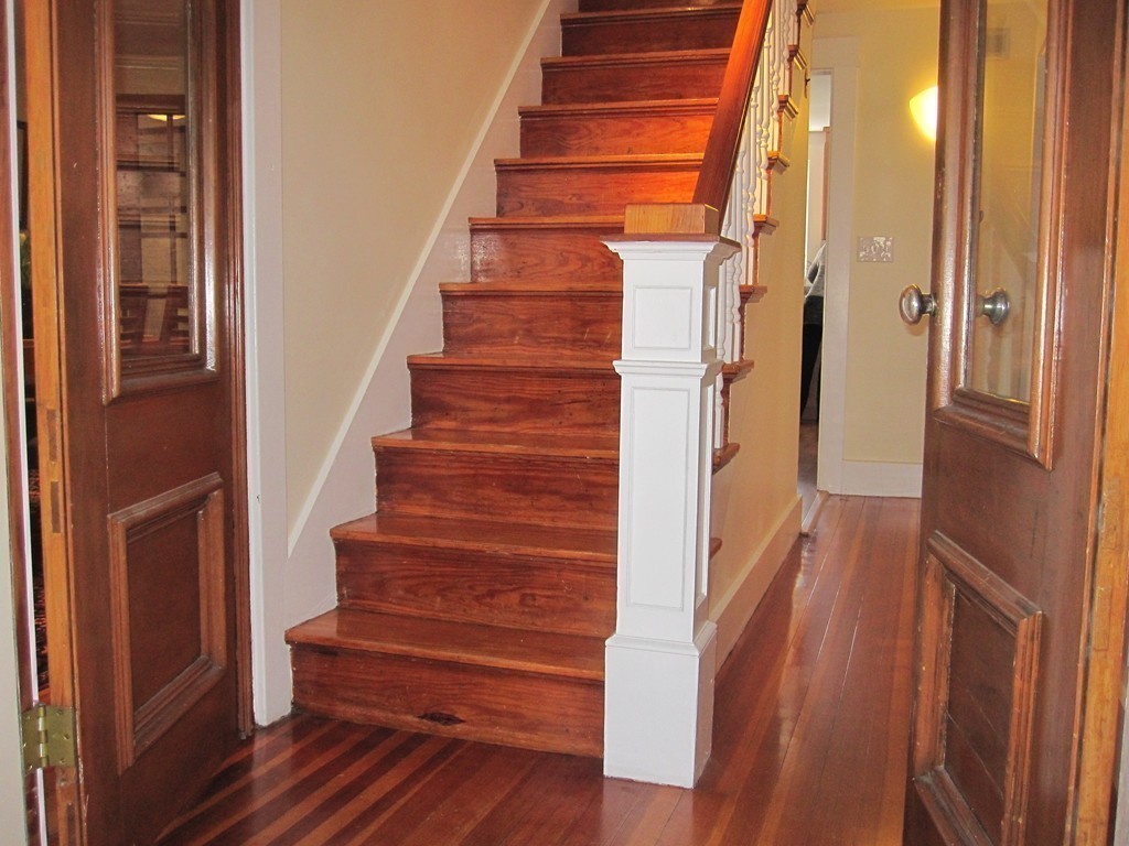 176 Parmenter Road Newton, MA 02465 - Photo 8 of 30 a view of staircase with wooden floor and black walls