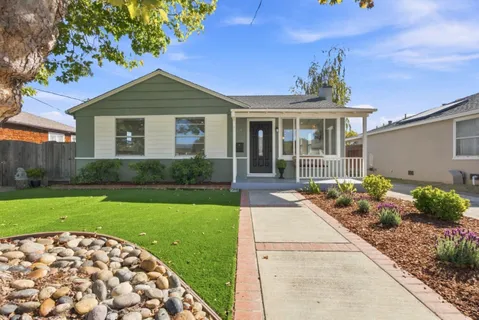 a front view of a house with garden