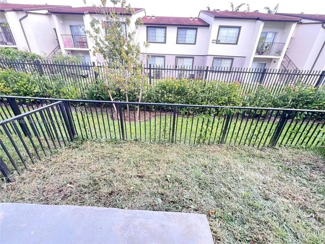 a view of a brick house with a yard