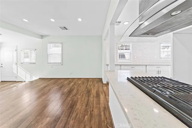 a view of a room with wooden floor