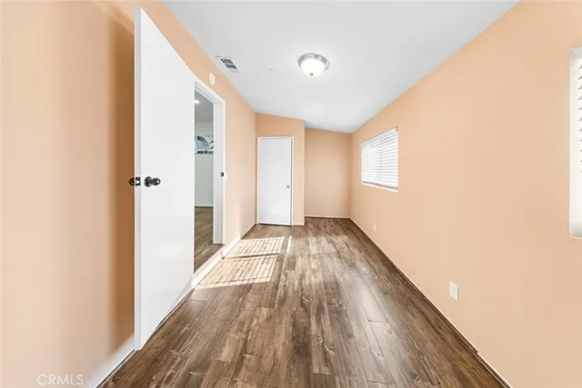 a view of a room with wooden floor and staircase