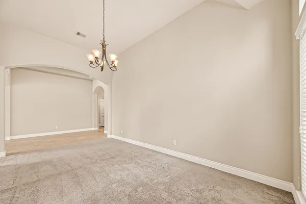 a view of a chandelier fan and entryway