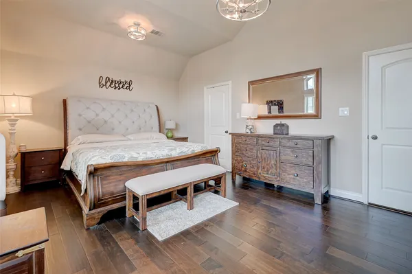 a bedroom with a bed and wooden furniture