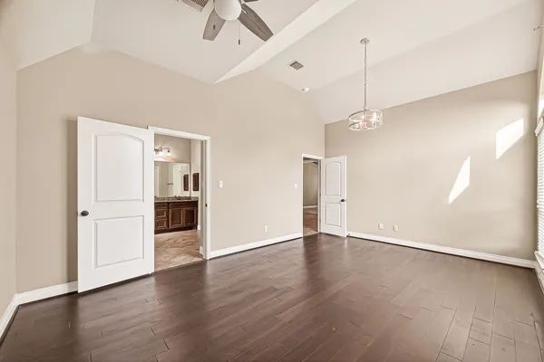 a view of an empty room with wooden floor