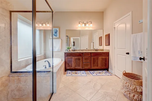 a bathroom with a granite countertop sink a mirror and a shower