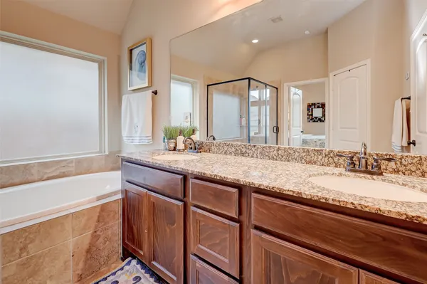 a bathroom with a granite countertop sink and a large mirror