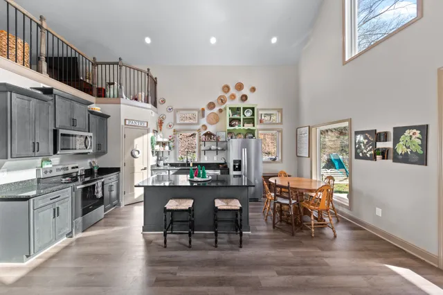 a kitchen with stainless steel appliances granite countertop a sink and cabinets
