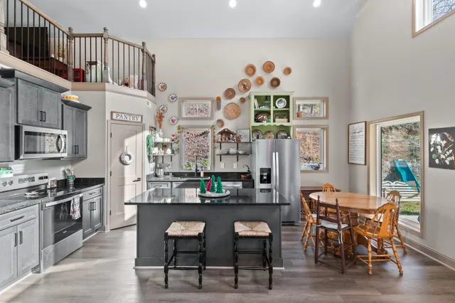 a kitchen with stainless steel appliances granite countertop a sink and cabinets