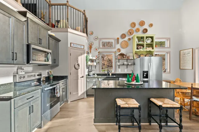 a view of a hallway with furniture and wooden floor