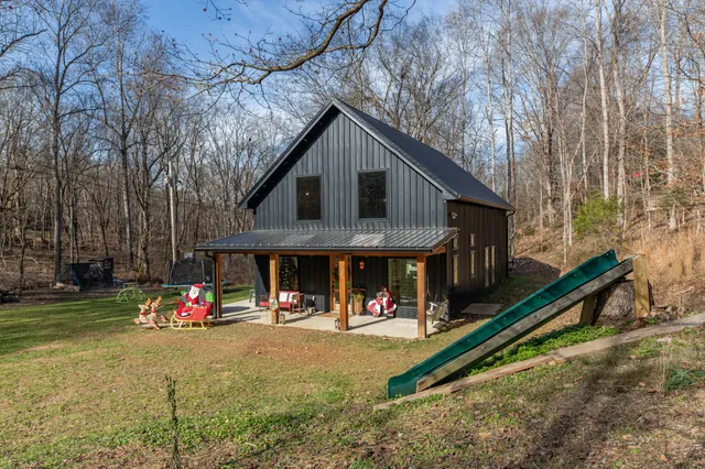 a view of a house with a yard and garage