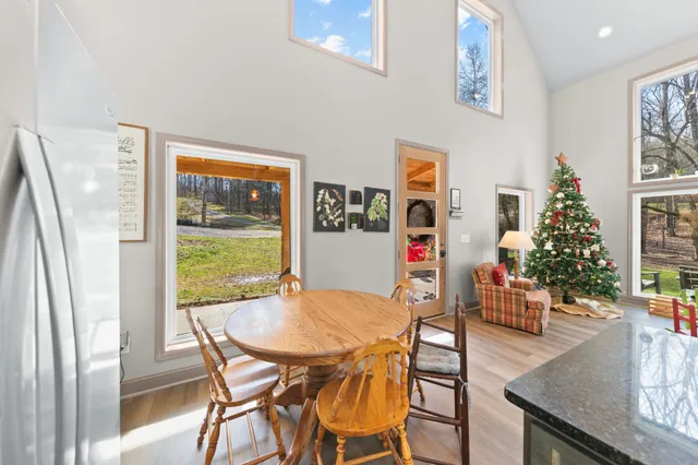 a living room with furniture a desk and chair with wooden floor