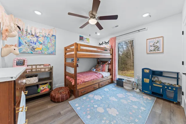 a bedroom with furniture and wooden floor