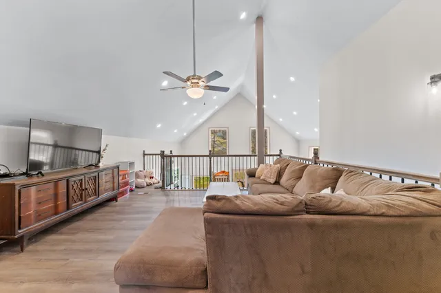 a living room with furniture and a wooden floor