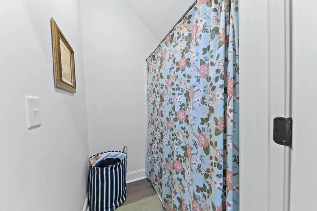 a view of a wooden house with a yard and sitting area