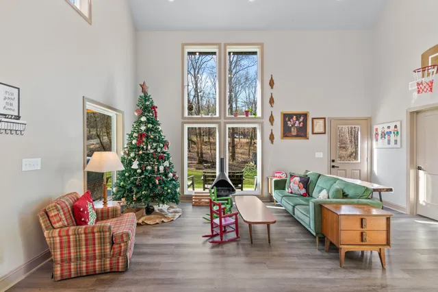 a kitchen with stainless steel appliances granite countertop a stove a refrigerator a dining table and chairs with wooden floor