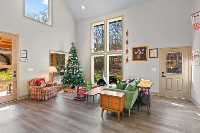 a living room with stainless steel appliances kitchen island granite countertop furniture a dining table and chairs