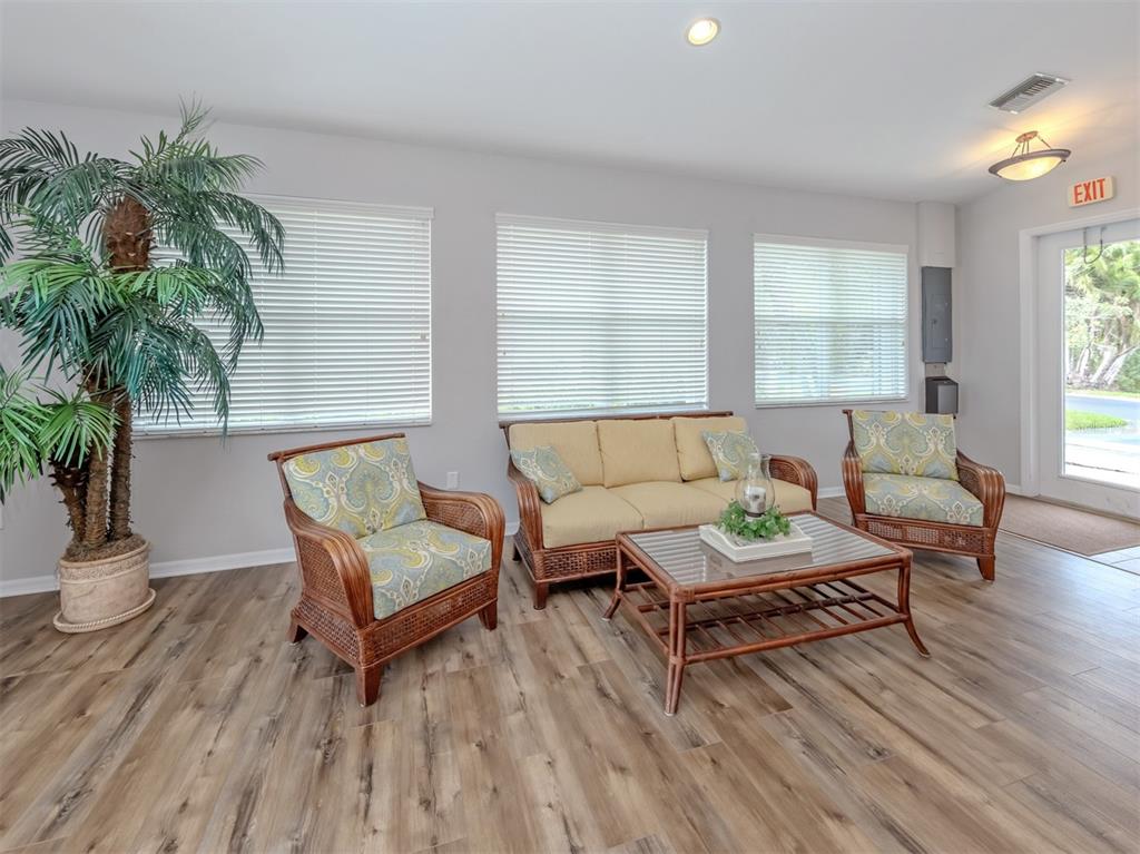 205 Reclinata Circle Venice, FL 34292 - Photo 39 of 62 a living room with furniture and a wooden floor