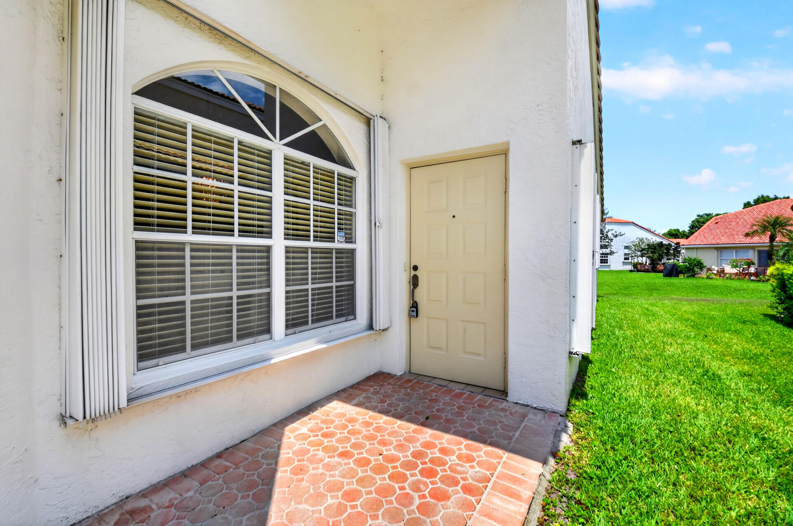 15340 Floral Club Road Delray Beach, FL 33484 - Photo 3 of 42 a front view of a house with a yard