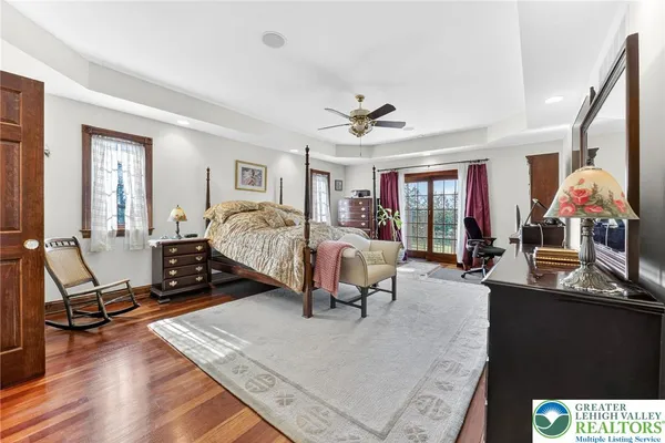 a view of a living room with wooden floor and painting on the wall