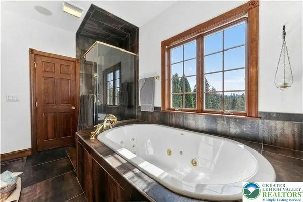 a bedroom with a bed window and a flat screen tv