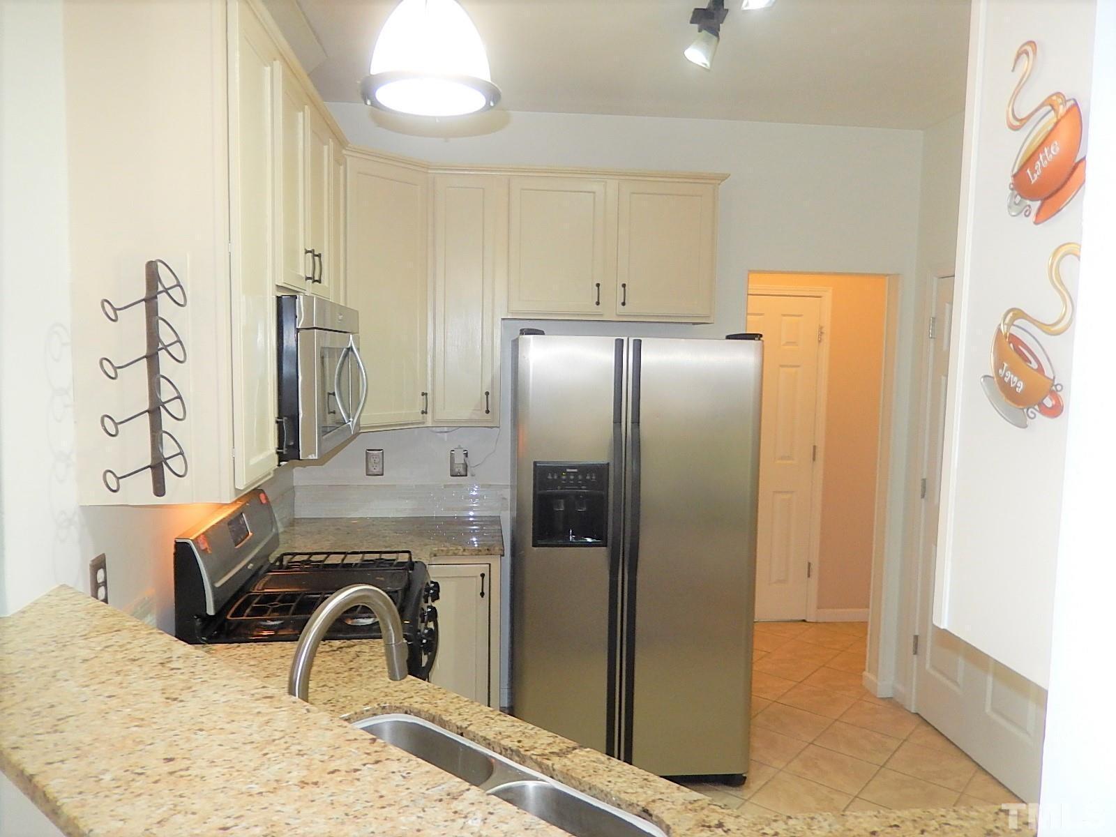 4717 Delta Ridge Court Raleigh, NC 27612 - Photo 6 of 30 a bathroom with a granite countertop sink a mirror and shower