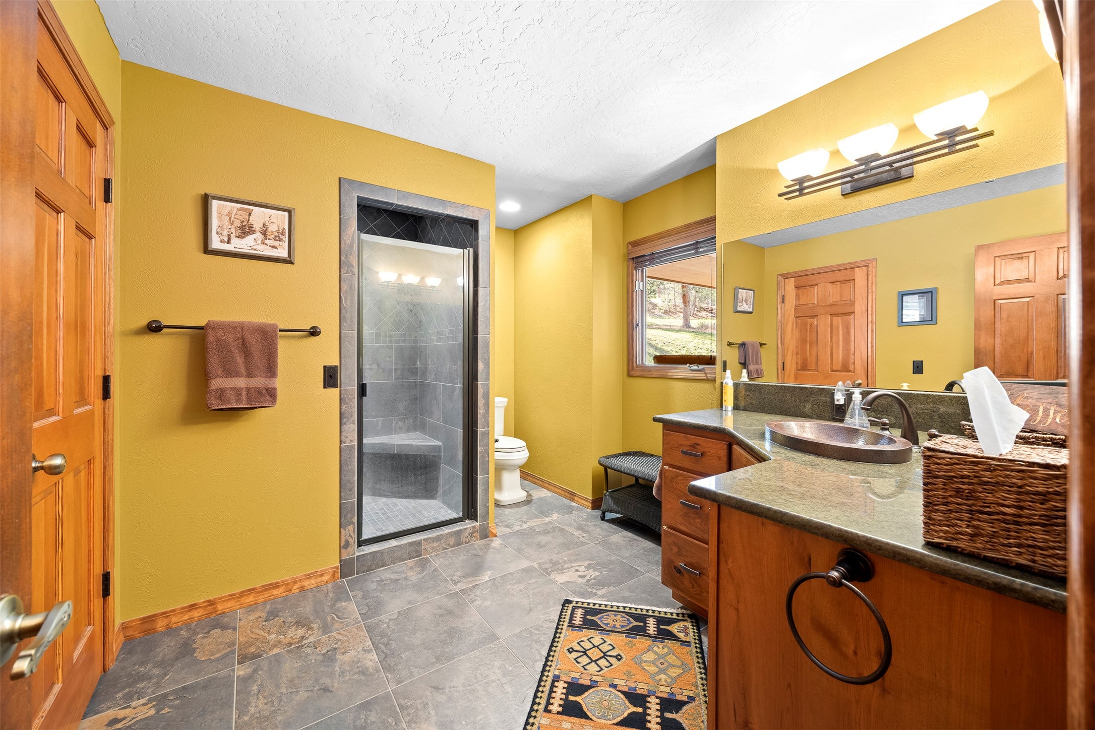 730 Big Flat Road Missoula, MT 59804 - Photo 29 of 59 Full bath featuring vanity, a shower stall, and a textured ceiling