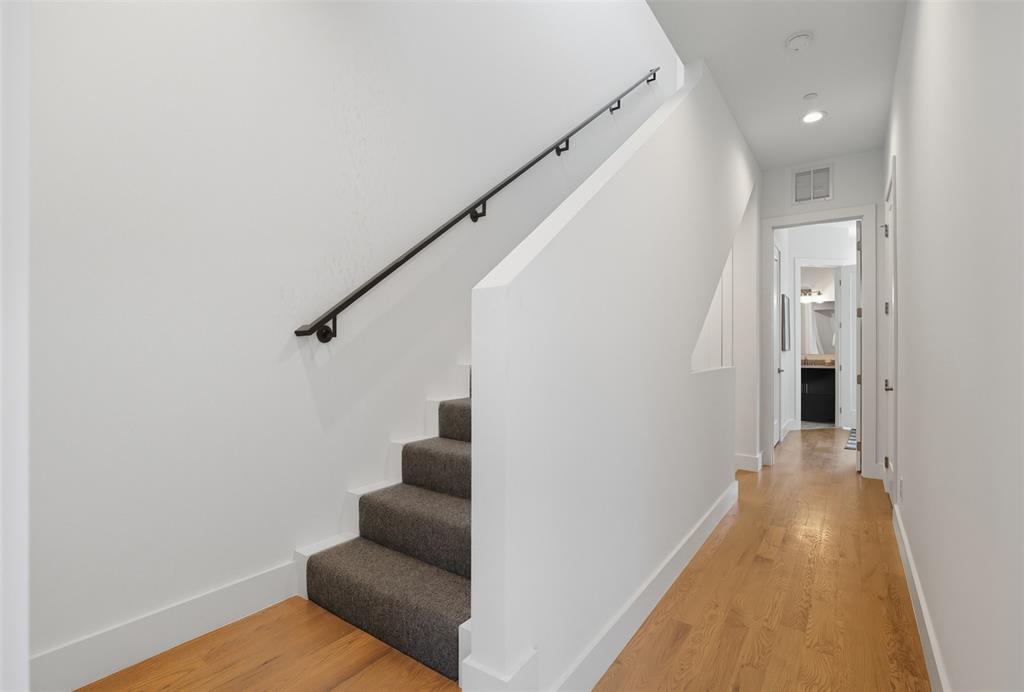 4517 Munger Avenue, Unit 101 Dallas, TX 75204 - Photo 17 of 39 a view of a hallway with wooden floor and staircase