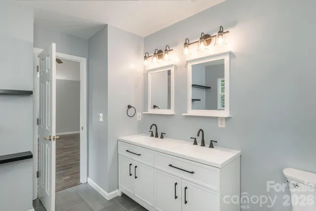 a bathroom with a sink vanity and mirror