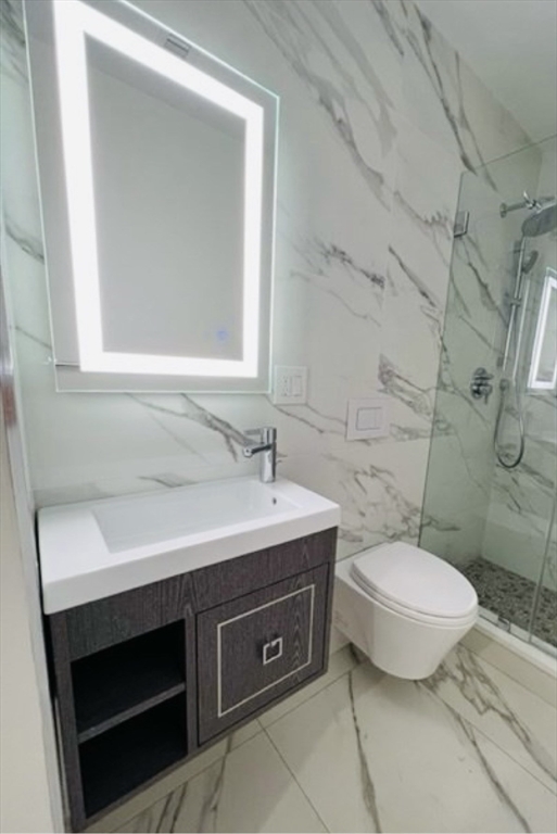 18 Grove Street, Unit 4 Boston, MA 02114 - Photo 11 of 17 a bathroom with a sink toilet and mirror