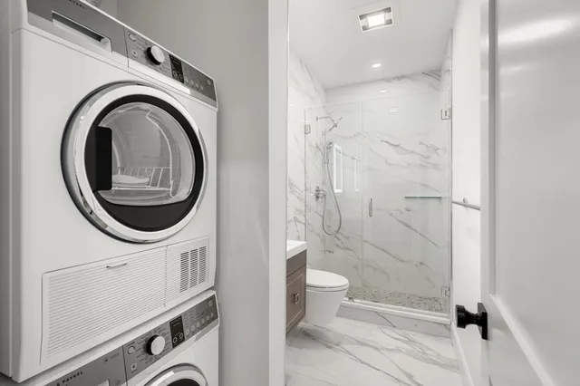 a bathroom with a toilet a sink and a shower