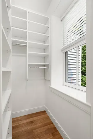 a view of a room with rack on the wall and a window