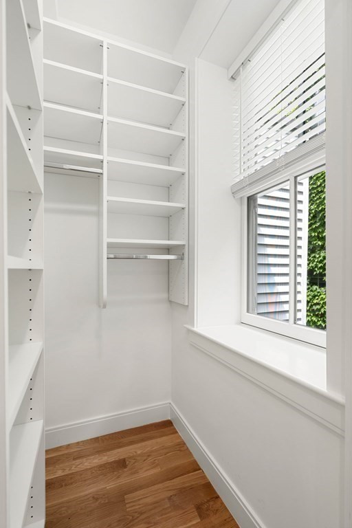 18 Grove Street, Unit 4 Boston, MA 02114 - Photo 9 of 17 a view of a room with rack on the wall and a window