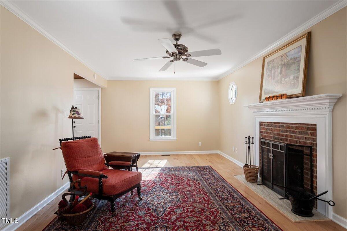 7120 Sandringham Drive Raleigh, NC 27613 - Photo 10 of 40 a living room with furniture and a fireplace
