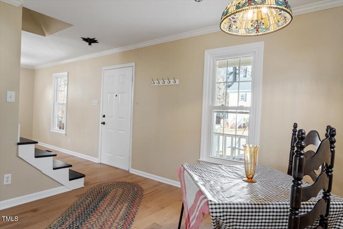 7120 Sandringham Drive Raleigh, NC 27613 - Photo 11 of 40 a bedroom with a bed and wooden floor