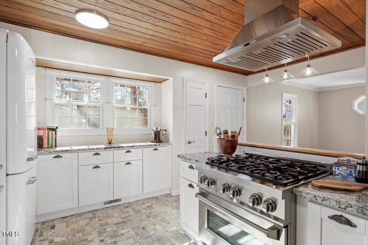 7120 Sandringham Drive Raleigh, NC 27613 - Photo 15 of 40 a kitchen with stove a sink and cabinets