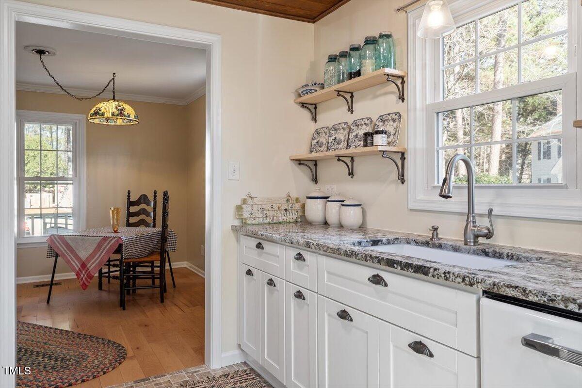 7120 Sandringham Drive Raleigh, NC 27613 - Photo 18 of 40 a living room with granite countertop furniture and a window