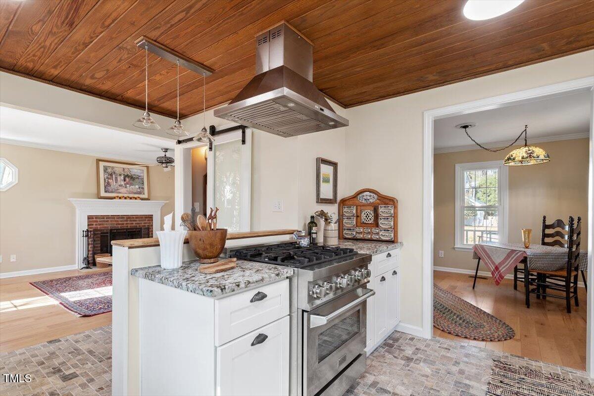 7120 Sandringham Drive Raleigh, NC 27613 - Photo 19 of 40 a kitchen with stainless steel appliances granite countertop a stove and a sink