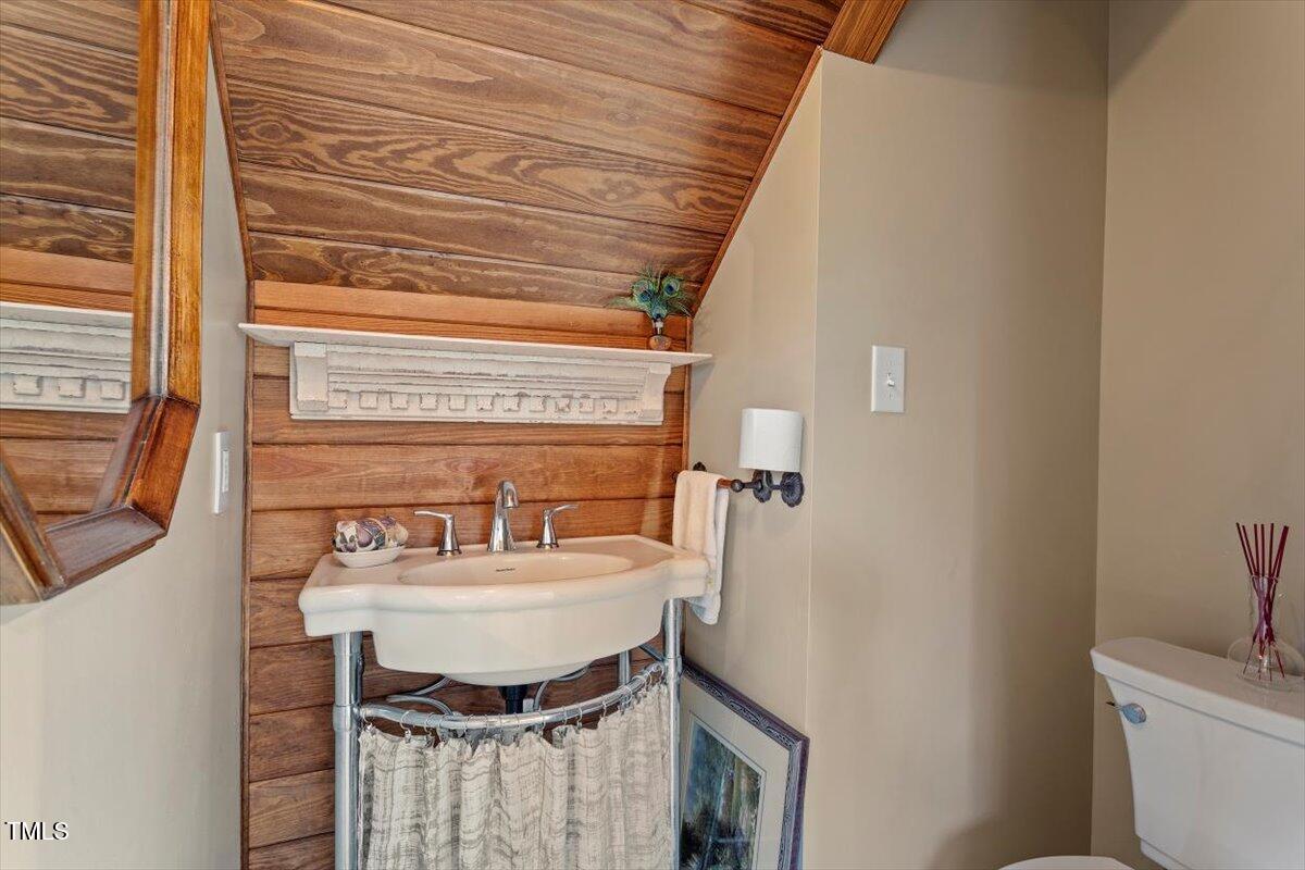 7120 Sandringham Drive Raleigh, NC 27613 - Photo 22 of 40 a bathroom with a sink and a mirror