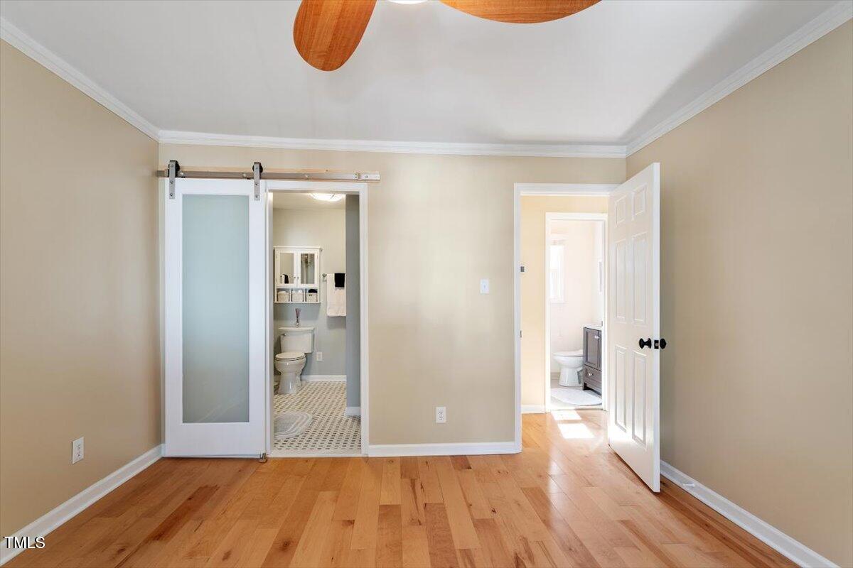 7120 Sandringham Drive Raleigh, NC 27613 - Photo 24 of 40 a view of a room with wooden floor and a bathroom
