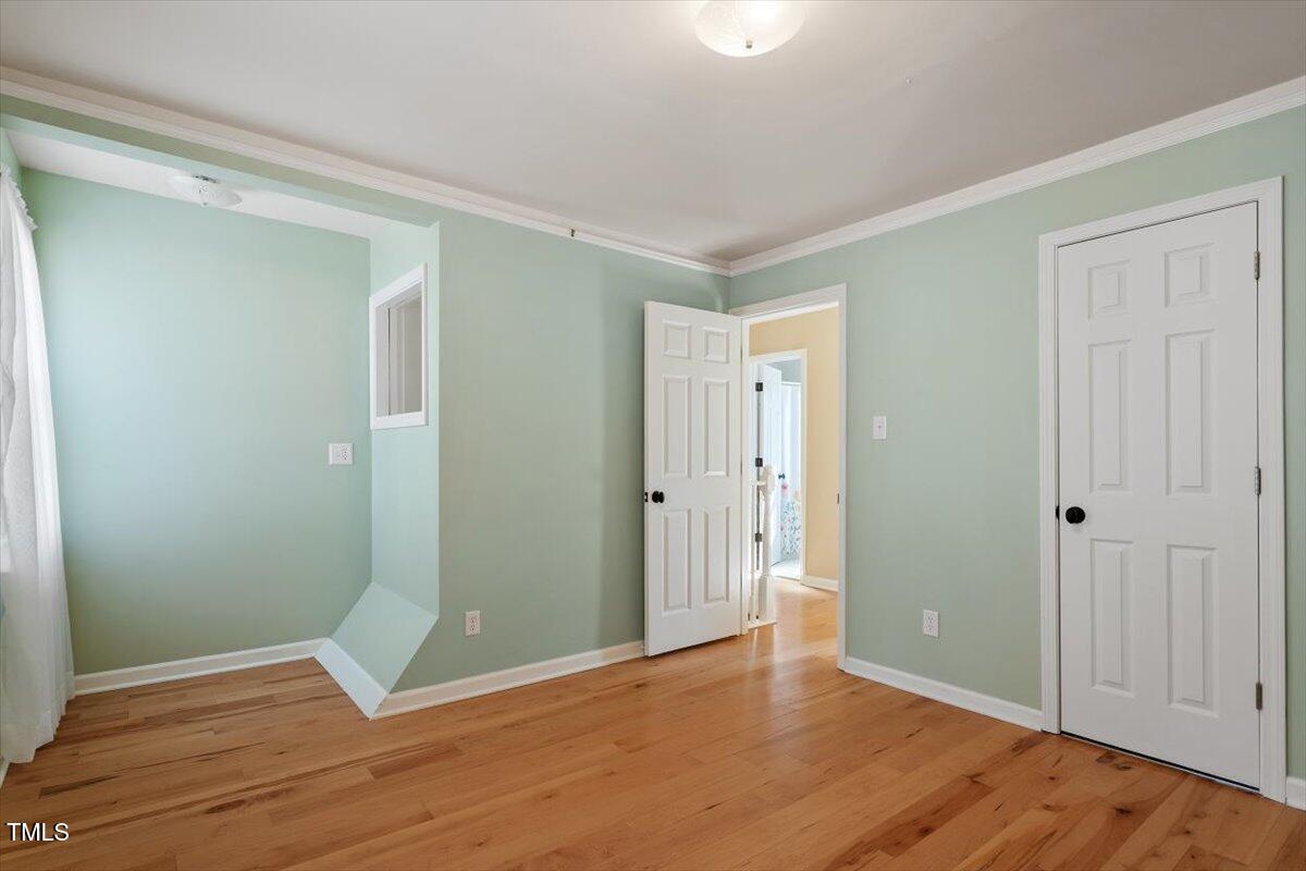7120 Sandringham Drive Raleigh, NC 27613 - Photo 28 of 40 a view of an empty room with wooden floor and closet