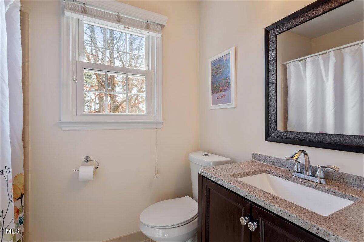 7120 Sandringham Drive Raleigh, NC 27613 - Photo 30 of 40 a bathroom with a granite countertop bathtub sink vanity mirror and toilet