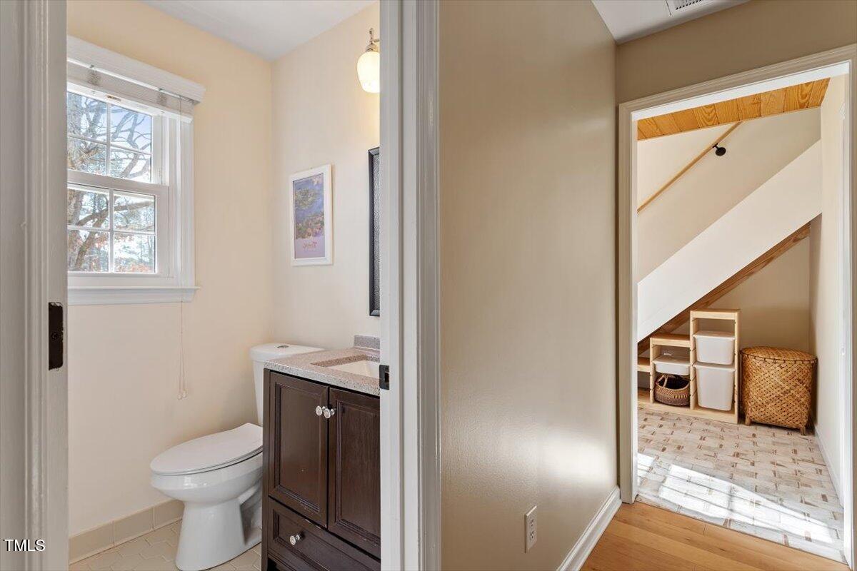 7120 Sandringham Drive Raleigh, NC 27613 - Photo 31 of 40 a bathroom with a granite countertop toilet sink and mirror