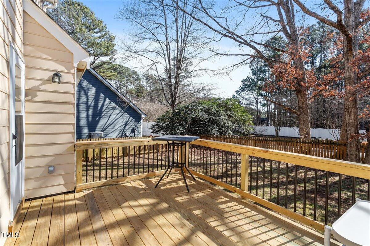 7120 Sandringham Drive Raleigh, NC 27613 - Photo 37 of 40 a view of balcony with wooden floor and fence