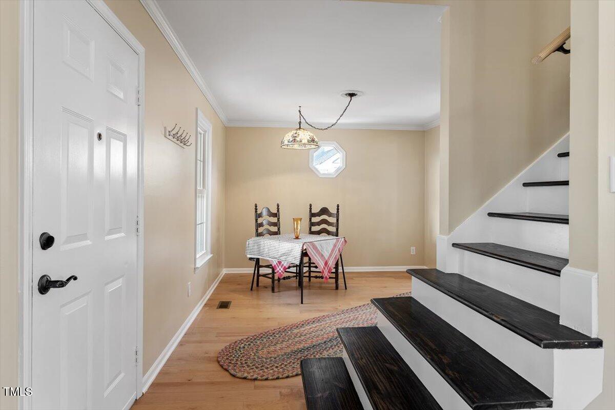 7120 Sandringham Drive Raleigh, NC 27613 - Photo 4 of 40 a view of a livingroom with furniture and hardwood floor